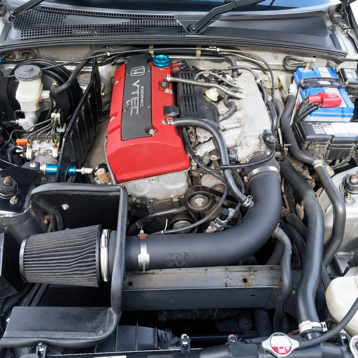 Honda VTEC engine bay with a cone air filter and intake pipe