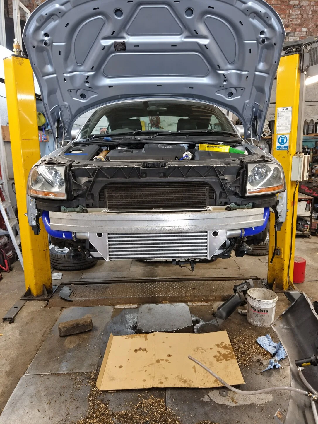 Silver Audi TT with the front bumper removed and a Forge front-mount intercooler visible