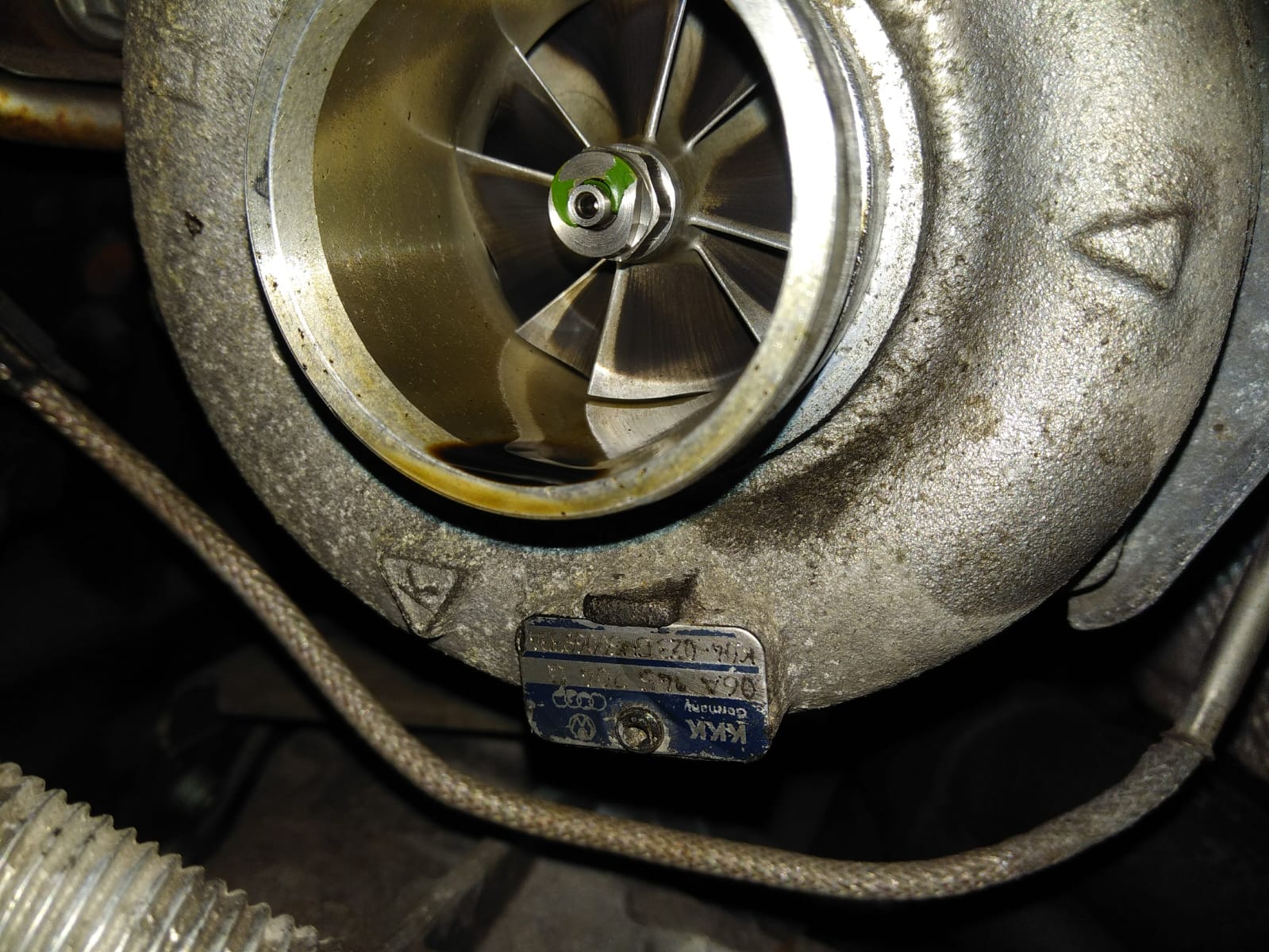 Close-up of a turbocharger compressor wheel and metal housing in the workshop